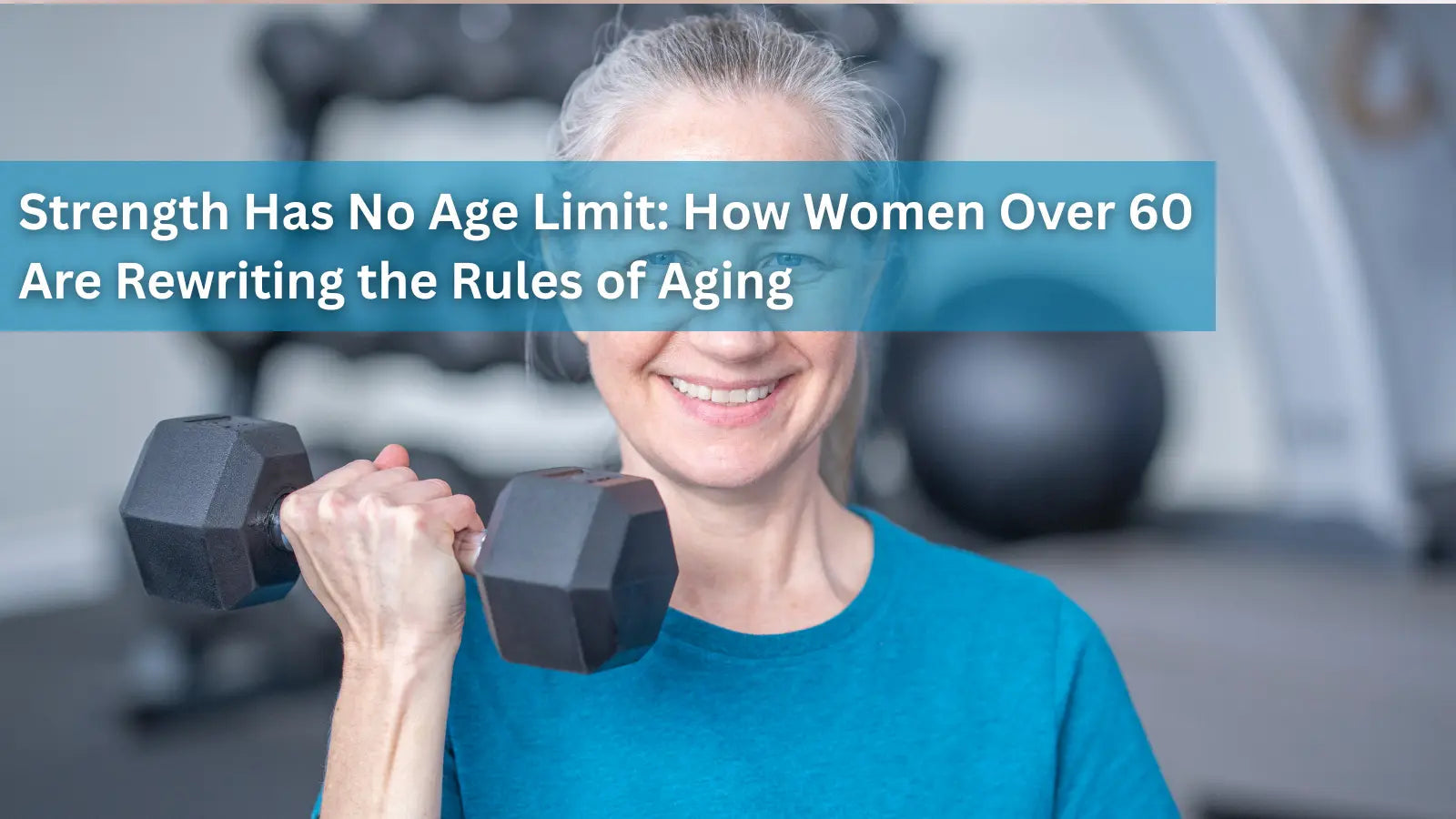 A smiling older woman with grey hair lifting a black dumbbell in a gym setting.