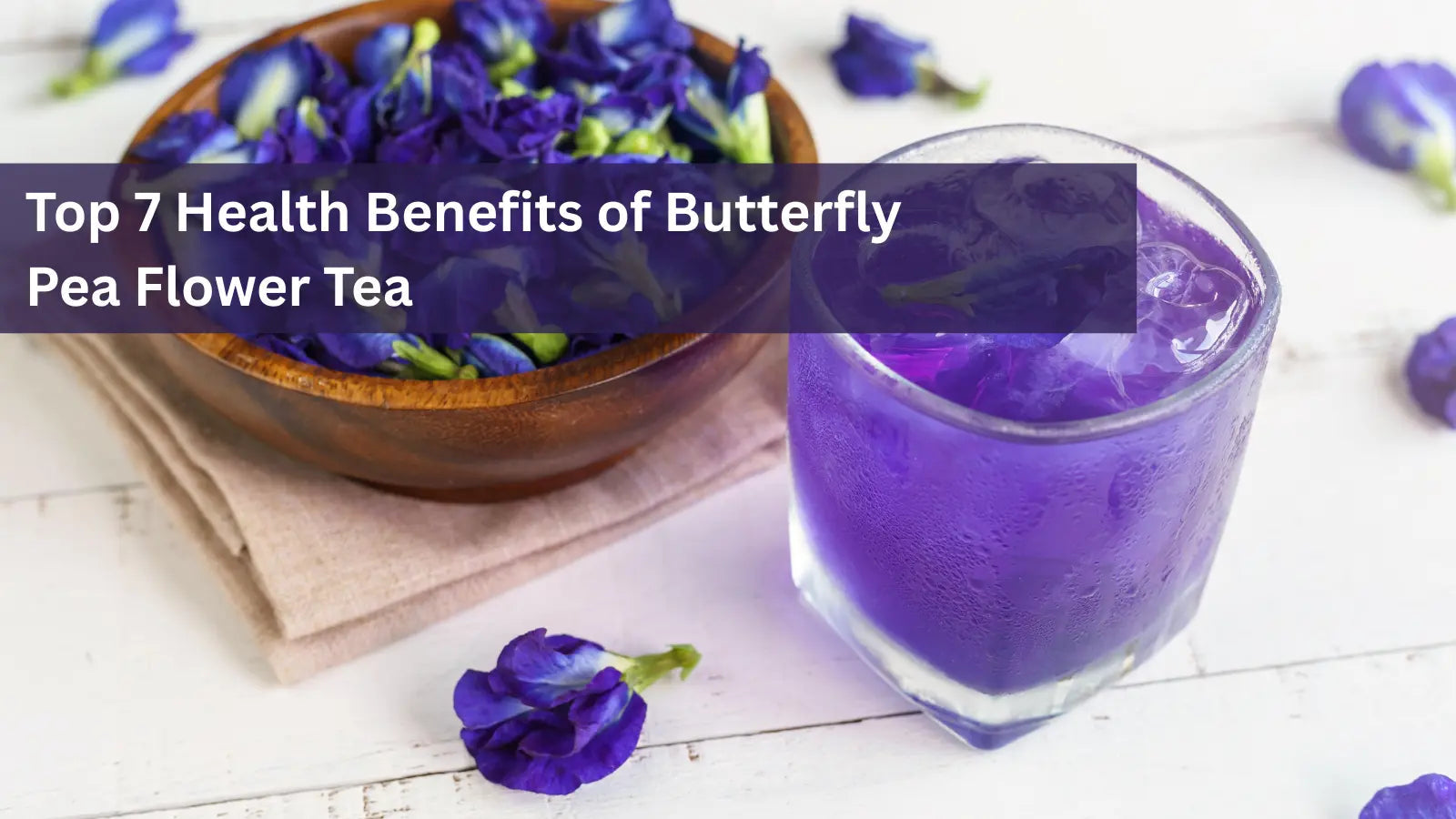 This image features a glass of vibrant blue liquid, highlighting the top 7 health benefits of butterfly pea flower tea (also known as blue tea).