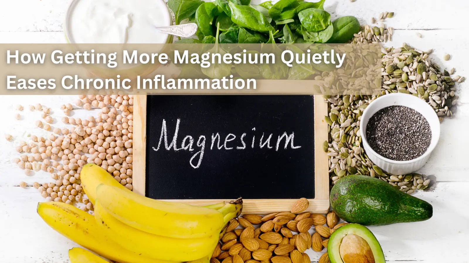 Overhead of foods rich in magnesium, including chickpeas, bananas, spinach, and nuts, with a chalkboard sign that says "Magnesium."