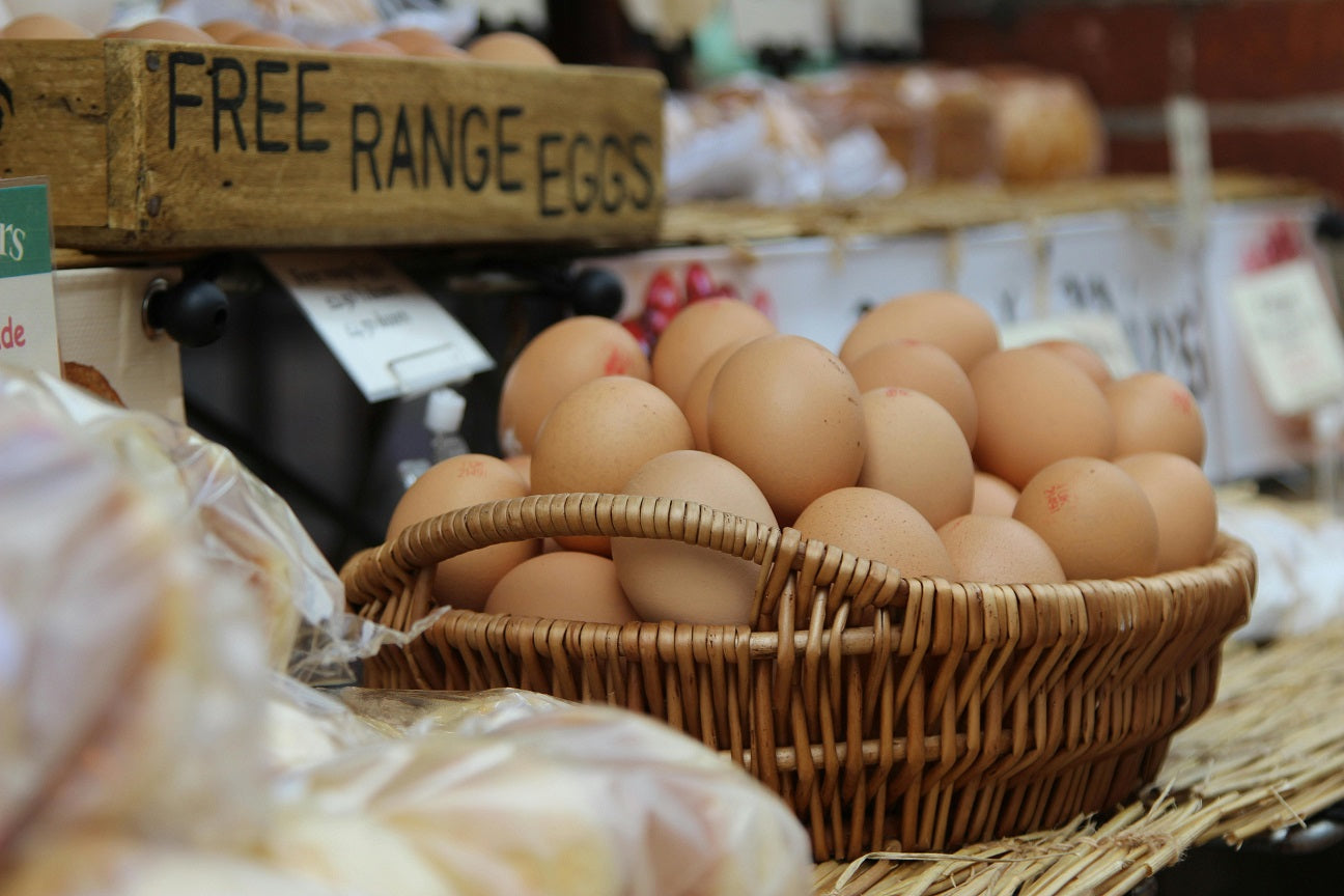 A basket of brown eggs at a market.
